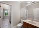 Bathroom boasts a vanity with granite counters, a large mirror, and a tiled shower and flooring at 6138 Greatwater Dr, Windermere, FL 34786