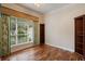 Bedroom with hardwood floors, a ceiling fan, and a large window providing ample natural light at 6138 Greatwater Dr, Windermere, FL 34786