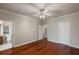 This primary bedroom offers an en-suite bathroom and closet space, with hardwood floors and ceiling fan at 6138 Greatwater Dr, Windermere, FL 34786