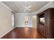 Bedroom featuring hardwood floors, neutral walls, and a built in entertainment center at 6138 Greatwater Dr, Windermere, FL 34786