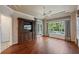Bedroom featuring hardwood floors and large windows overlooking the serene pool area at 6138 Greatwater Dr, Windermere, FL 34786
