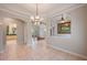 Spacious room with tile floors, a decorative chandelier, and large arched openings at 6138 Greatwater Dr, Windermere, FL 34786