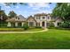 Stunning two-story home with a lush green lawn, manicured landscaping, and stone accents at 6138 Greatwater Dr, Windermere, FL 34786