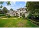 Beautiful two-story house with manicured lawns, mature landscaping, and an inviting walkway at 6138 Greatwater Dr, Windermere, FL 34786