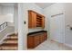 Hallway boasting beautiful wooden cabinets and drawers with black granite countertops at 6138 Greatwater Dr, Windermere, FL 34786