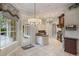 Eat-in kitchen featuring white cabinets, granite counters, and a chandelier lighting fixture at 6138 Greatwater Dr, Windermere, FL 34786