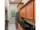 Well-organized laundry room featuring wood cabinets, granite countertops, and modern washer and dryer at 6138 Greatwater Dr, Windermere, FL 34786