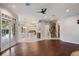 Open-concept living area with hardwood floors, large windows, and access to the kitchen and staircase at 6138 Greatwater Dr, Windermere, FL 34786
