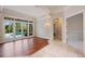 Bright living room featuring hardwood floors and glass doors leading to a pool view at 6138 Greatwater Dr, Windermere, FL 34786