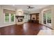 Living room with a fireplace, hardwood floors, windows, and an entertainment center at 6138 Greatwater Dr, Windermere, FL 34786