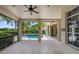 Covered porch with wood flooring overlooking the pool and manicured backyard is perfect for relaxing at 6138 Greatwater Dr, Windermere, FL 34786