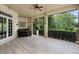 Covered porch with an outdoor kitchen and bar area that offers views of the lush green backyard at 6138 Greatwater Dr, Windermere, FL 34786