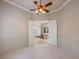 Carpeted room featuring paneled walls and a ceiling fan, with a glimpse into another room at 6138 Greatwater Dr, Windermere, FL 34786