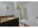 Well-lit bathroom featuring a granite countertop vanity, a shower and tub combo, and tile flooring at 617 Marsh Reed Dr, Winter Garden, FL 34787