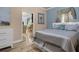 This bedroom features tan and light blue walls with a decorative window treatment and matching bedding at 617 Marsh Reed Dr, Winter Garden, FL 34787