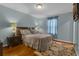 Serene bedroom with hardwood floors, a luxurious bed, side tables, and a decorative rug for added comfort at 617 Marsh Reed Dr, Winter Garden, FL 34787