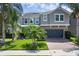 Beautiful two-story home with a paver driveway, lush landscaping, and a two-car garage at 617 Marsh Reed Dr, Winter Garden, FL 34787
