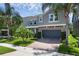 Beautiful two-story home with a paver driveway, lush landscaping, and a two-car garage at 617 Marsh Reed Dr, Winter Garden, FL 34787
