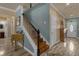 Entryway features a wooden staircase, a decorative fireplace, and tile flooring throughout at 617 Marsh Reed Dr, Winter Garden, FL 34787
