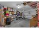 Spacious garage interior filled with various storage items and an overhead rack at 617 Marsh Reed Dr, Winter Garden, FL 34787