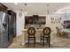 Kitchen island with granite countertops and stainless appliances; open to the dining area at 617 Marsh Reed Dr, Winter Garden, FL 34787
