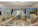 Elegant formal living room with ornate chandelier and matching furniture at 617 Marsh Reed Dr, Winter Garden, FL 34787