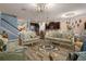 Formal living area leading to kitchen with tiled floors, chandelier, and ornate furniture at 617 Marsh Reed Dr, Winter Garden, FL 34787
