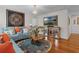 Living room with a chandelier, hardwood floors, light blue sofas, and decorative accents at 617 Marsh Reed Dr, Winter Garden, FL 34787