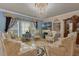 Elegant formal living room with ornate chandelier and matching furniture at 617 Marsh Reed Dr, Winter Garden, FL 34787