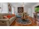 Living room with a chandelier, decorative wall art, hardwood floors, and light blue sofas at 617 Marsh Reed Dr, Winter Garden, FL 34787