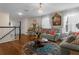 Living room with a chandelier, light blue sofas, and a round rug on hardwood floors at 617 Marsh Reed Dr, Winter Garden, FL 34787