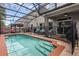 Backyard pool featuring a screened-in enclosure, patio, and mature landscaping at 617 Marsh Reed Dr, Winter Garden, FL 34787