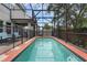 Large screened in pool with surrounding brick patio and safety fencing at 617 Marsh Reed Dr, Winter Garden, FL 34787