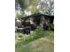 The covered patio overlooks an expansive backyard with lush lawn at 740 Naples Dr, Orlando, FL 32804