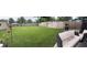 Spacious backyard features a large lawn, wood fence, patio area with furniture, and a bird feeder hanging in the yard at 740 Naples Dr, Orlando, FL 32804