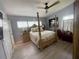 Relaxing bedroom features a four-poster bed and hardwood floors at 740 Naples Dr, Orlando, FL 32804