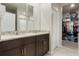 Bathroom with a double sink vanity, granite countertops, and a walk-in closet at 840 Teton St, Haines City, FL 33844