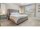 Comfortable bedroom with plush carpeting, a tufted headboard and plenty of natural light at 840 Teton St, Haines City, FL 33844