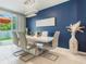 Bright dining room boasts a modern chandelier and sliding glass doors to the backyard at 840 Teton St, Haines City, FL 33844