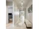 A brightly lit hallway features modern light fixtures and decorative mirrors at 840 Teton St, Haines City, FL 33844