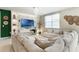 Inviting living room featuring a large sectional sofa, decorative shelving, and ample natural light at 840 Teton St, Haines City, FL 33844