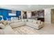 Open concept living and dining area with a large sectional sofa and modern kitchen at 840 Teton St, Haines City, FL 33844