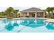 Community pool features a covered seating area and palm trees at 840 Teton St, Haines City, FL 33844