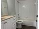 The bathroom offers a vanity with storage and a shower and tub combination at 8414 Sw 136Th Pl, Ocala, FL 34473