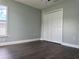Bedroom featuring bi-fold closet doors, a window and dark wood flooring at 8414 Sw 136Th Pl, Ocala, FL 34473