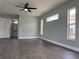 Spacious bedroom featuring dark wood flooring, a ceiling fan and natural light at 8414 Sw 136Th Pl, Ocala, FL 34473