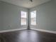 Neutral bedroom featuring two bright windows, dark wood floors and neutral paint at 8414 Sw 136Th Pl, Ocala, FL 34473