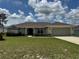 Charming one-story home with a well-manicured lawn and attached two-car garage on a sunny day at 8414 Sw 136Th Pl, Ocala, FL 34473