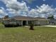 Inviting one-story home with fresh landscaping, lush green lawn, and attached two-car garage at 8414 Sw 136Th Pl, Ocala, FL 34473