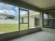 View of the screened lanai showcasing the outdoor living space and serene backyard at 8414 Sw 136Th Pl, Ocala, FL 34473